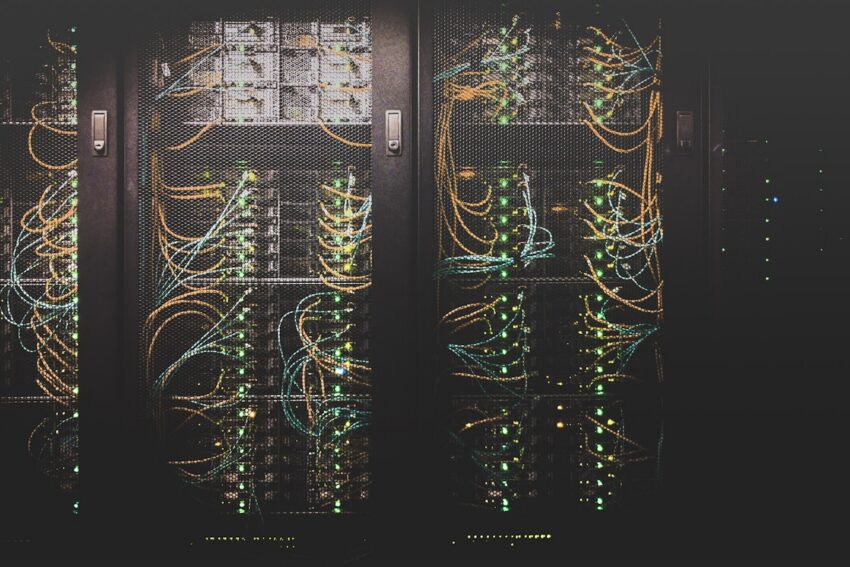 Dark server racks with green status lights during automated deploys